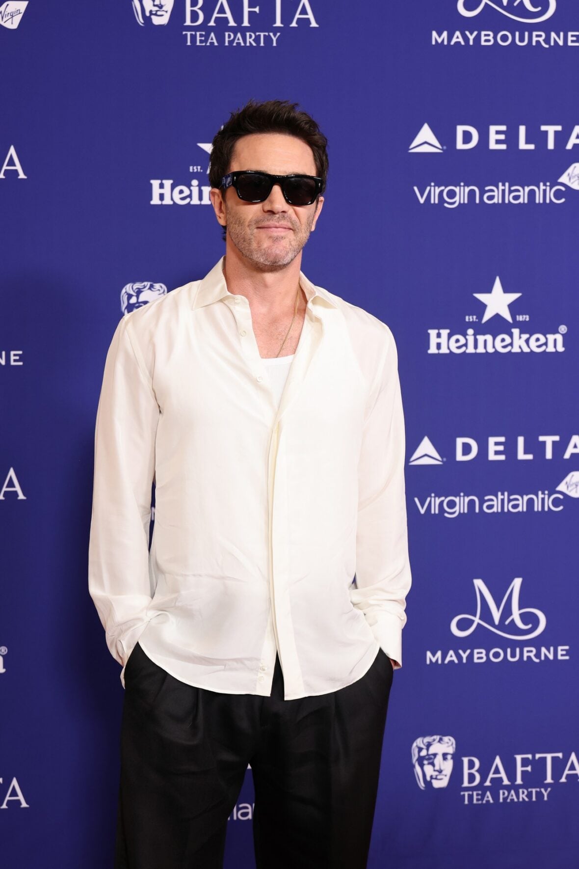 Tom Pelphrey poses on the red carpet at the BAFTA TV Tea Party