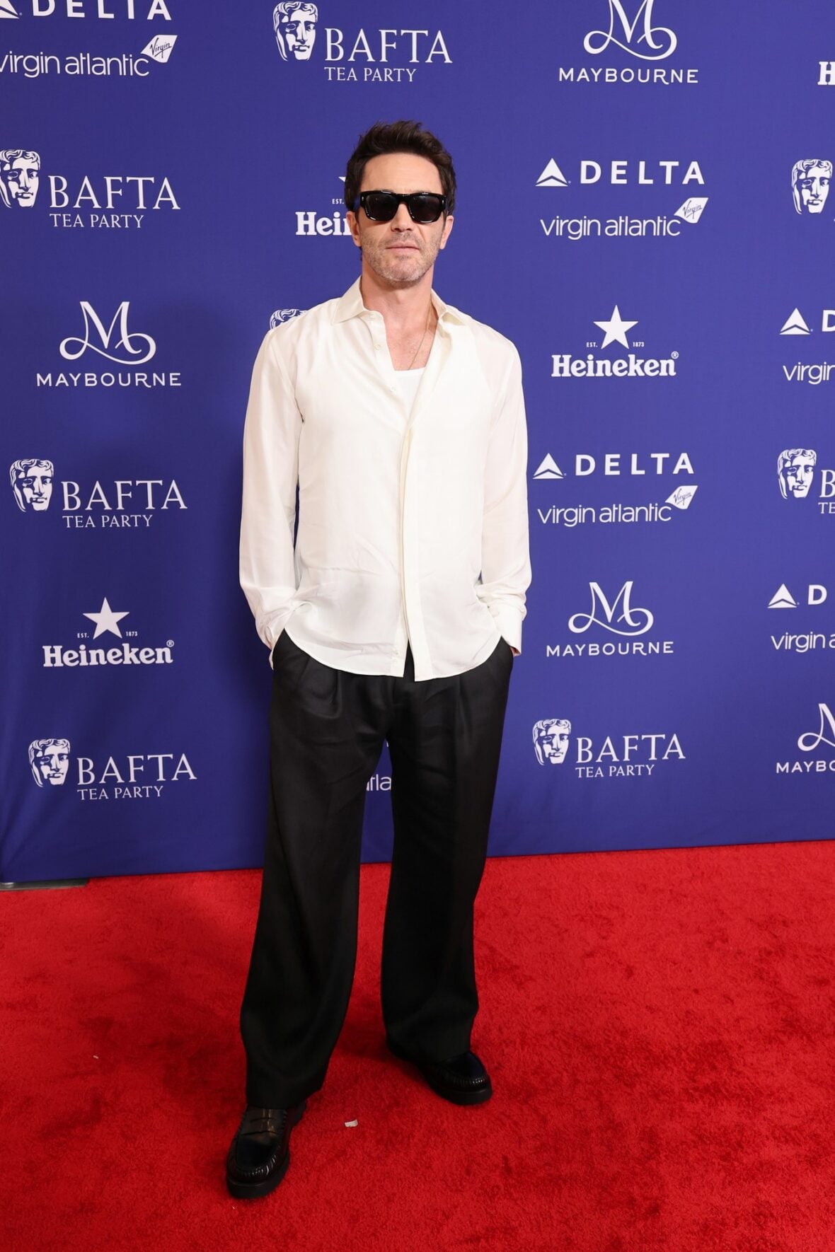 Tom Pelphrey poses on the red carpet at the BAFTA TV Tea Party