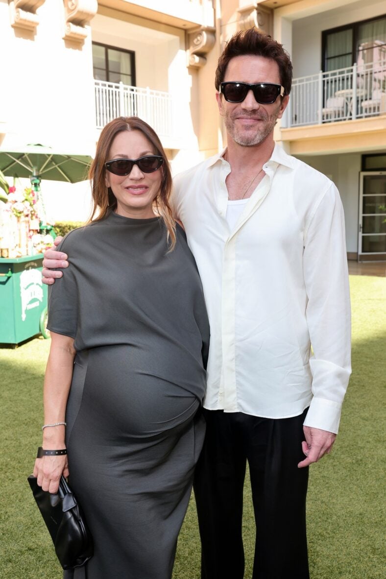 Kaley Cuoco and Tom Pelphrey pose inside at the BAFTA TV Tea Party
