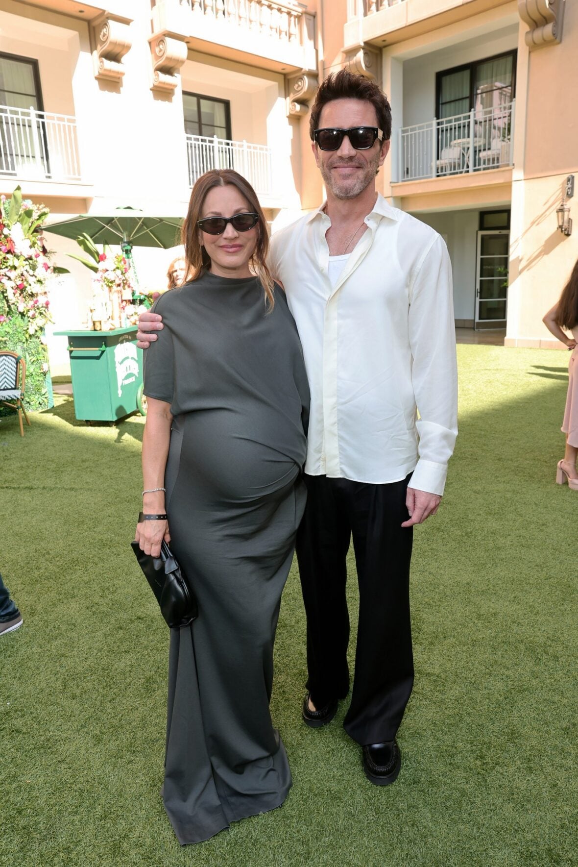 Kaley Cuoco and Tom Pelphrey pose inside at the BAFTA TV Tea Party