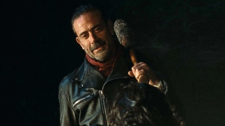 Jeffrey Dean Morgan as Negan, holding onto a bat and looking down in The Walking Dead.