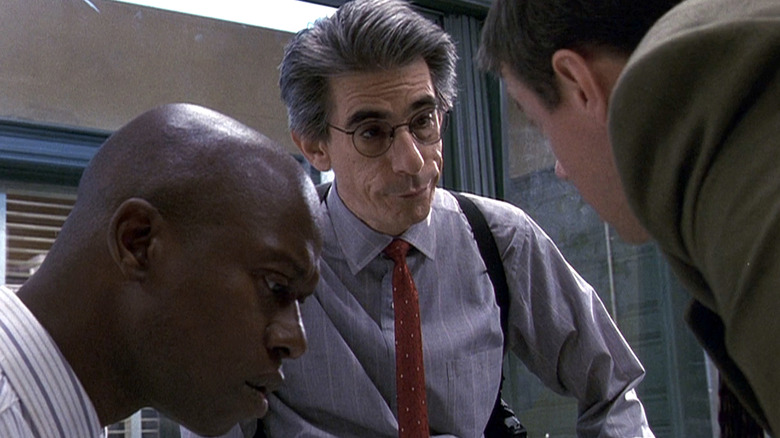 Frank Pembleton and John Munch looking at something in an office in Law & Order