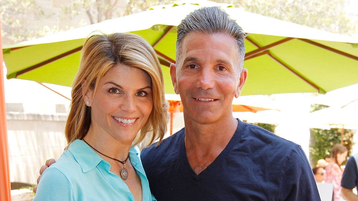 Lori Loughlin and Mossimo Giannulli smiling together in 2012
