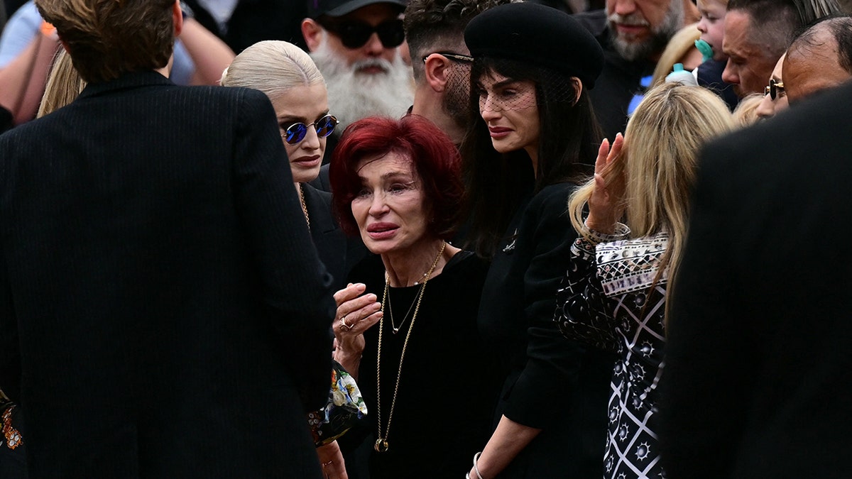 Sharon Osbourne and children crying at Ozzy Osbourne's funeral.