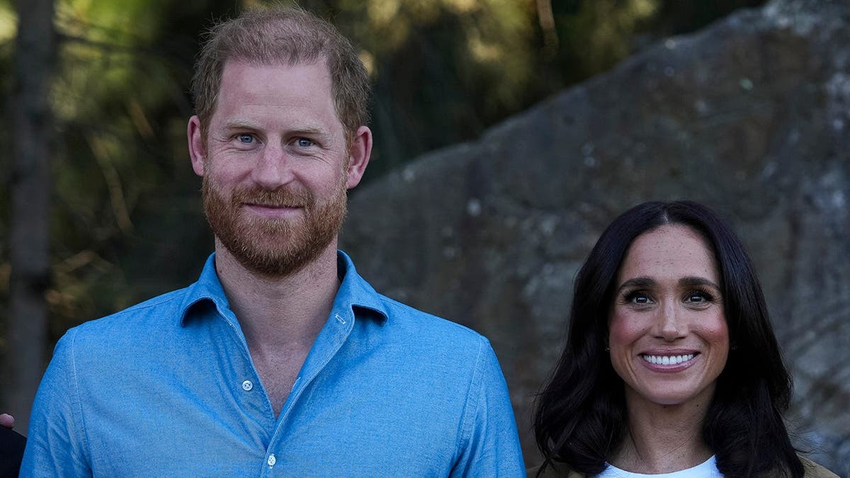 Prince Harry and Meghan, Duchess of Sussex, pose together during a Scar Tree Walk in Melbourne.