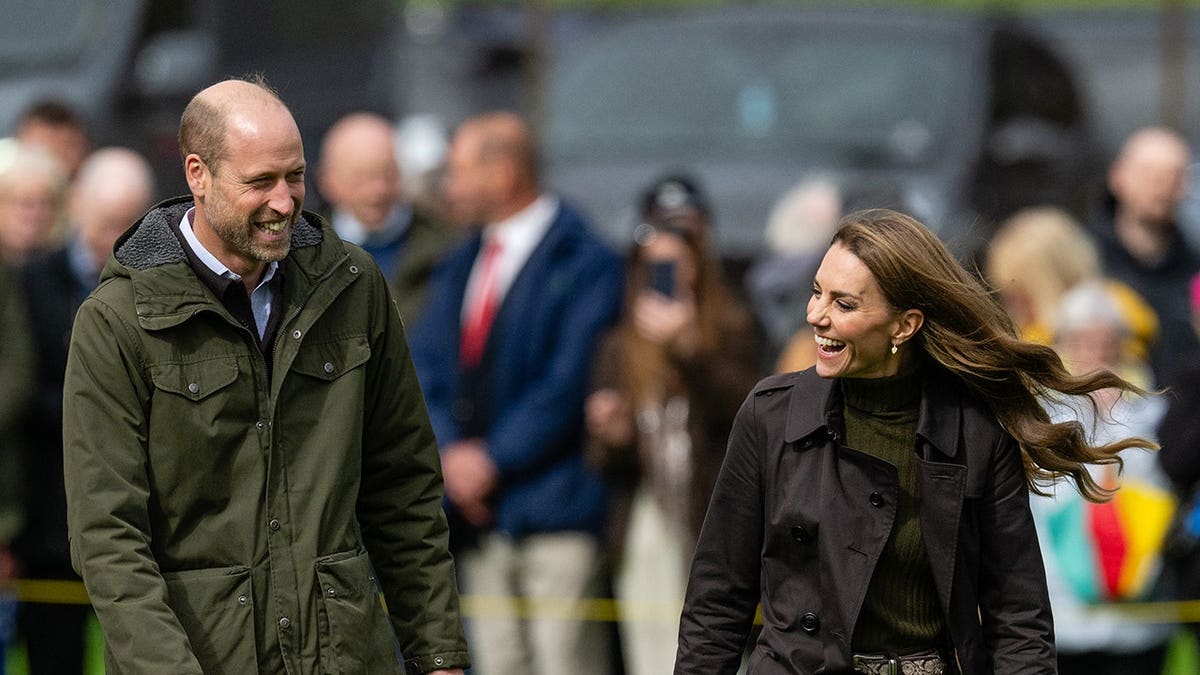 Prince William and Catherine, Princess of Wales, stand at Bute Shinty Club.