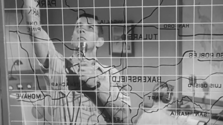 Leonard Nimoy's Air Force sergeant looks at a map in "Steve Canyon" (1958)