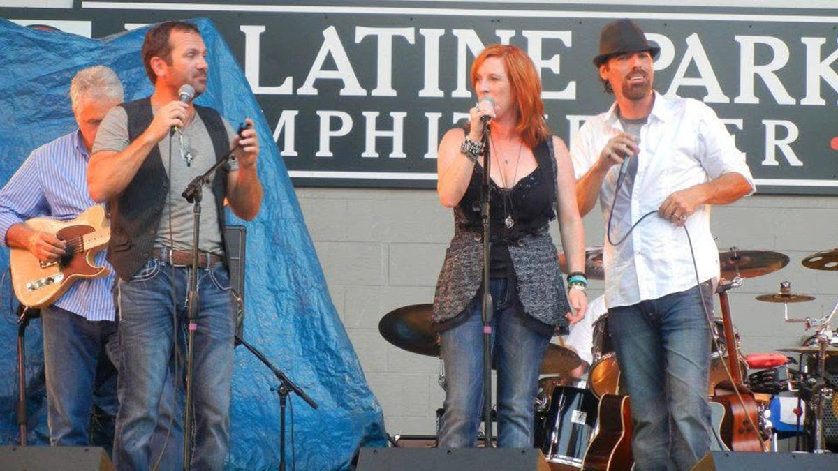Greg Duckworth, Wendy Williams and Brian Duckworth performing on stage together.