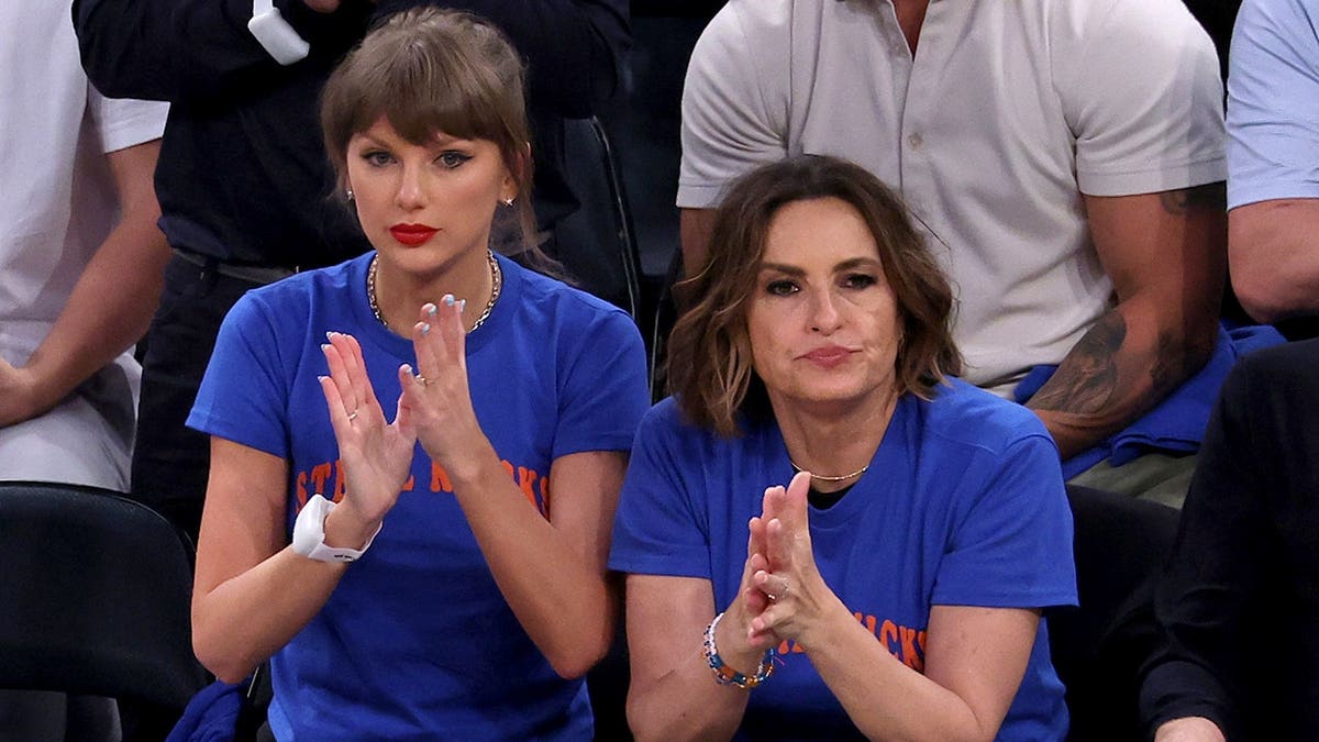 Taylor Swift and Mariska Hargitay seated at Madison Square Garden during NBA Finals game.