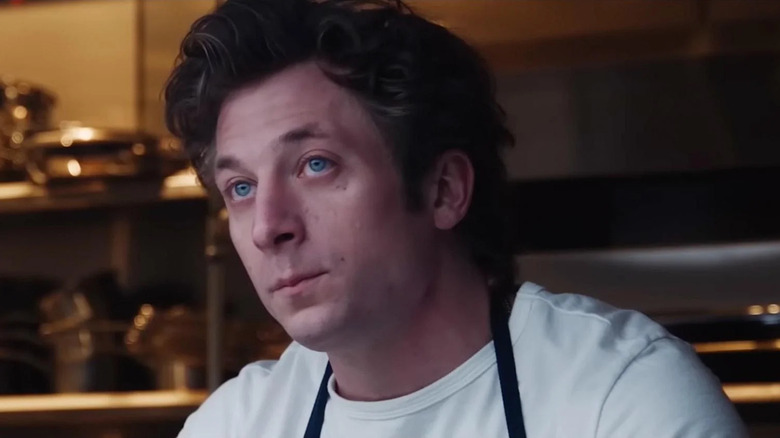 Jeremy Allen White as Carmy, looking up in The Bear.