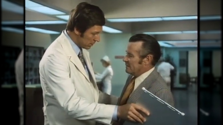 Dr. Hunter speaks to someone in a hospital corridor in "The Bold Ones: The New Doctors" (1969)
