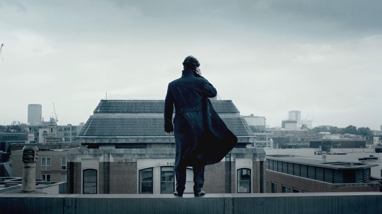 Benedict Cumberbatch as Sherlock Holmes, listening to a phone call looking out over London in Sherlock.
