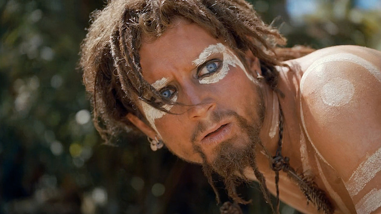 Ben Gunn looks up with long hair and painted skin