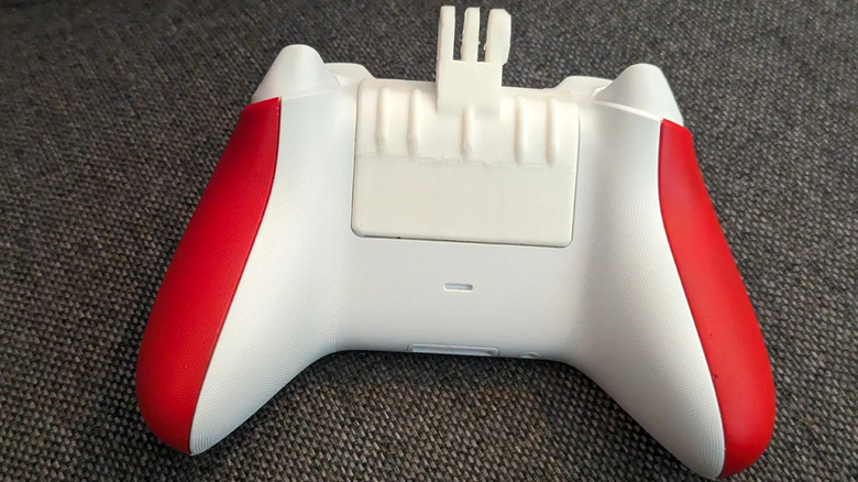 Xbox controller with a battery cover phone mount attached.