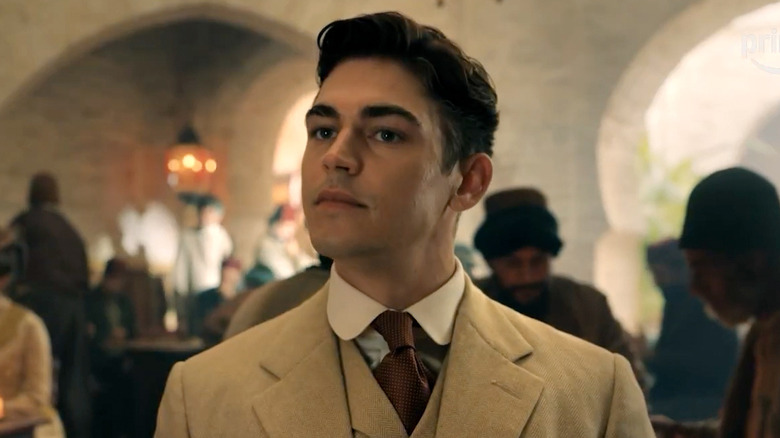 Hero Fiennes Tiffin as Sherlock Holmes, aiming his chin up in Young Sherlock.