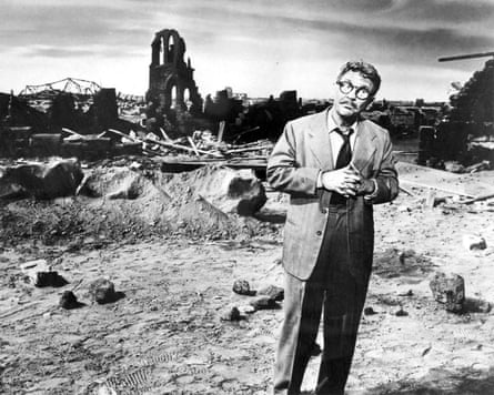 Burgess Meredith) in in front of ruined buildings