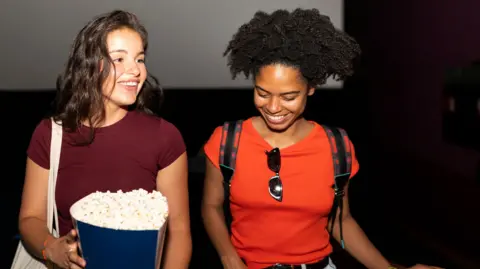 Getty Images Two young women at the cinema
