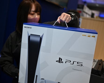 An employee prepares the Sony PlayStation 5 for sale.