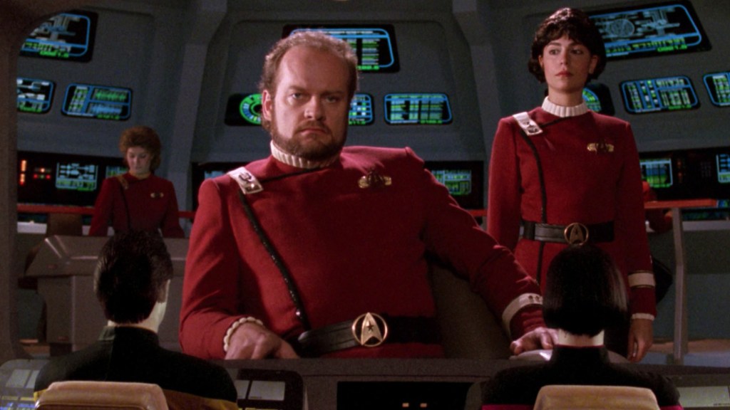Captain Morgan Bateman sitting in the captain's chair of the Bozeman with his first officer next to him