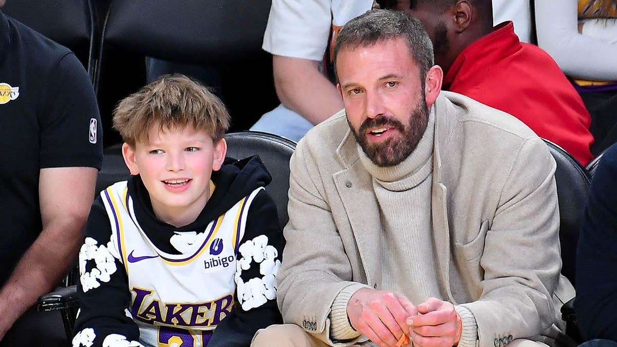 Ben Affleck and his son Samuel Garner Affleck seated at a basketball game.