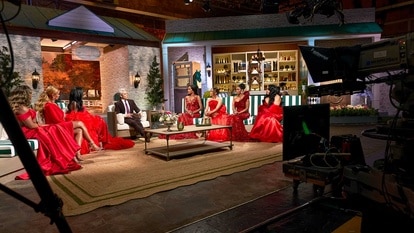 The set of the Real Housewives of Potomac Season 10 Reunion with the cast seated and cameras filming