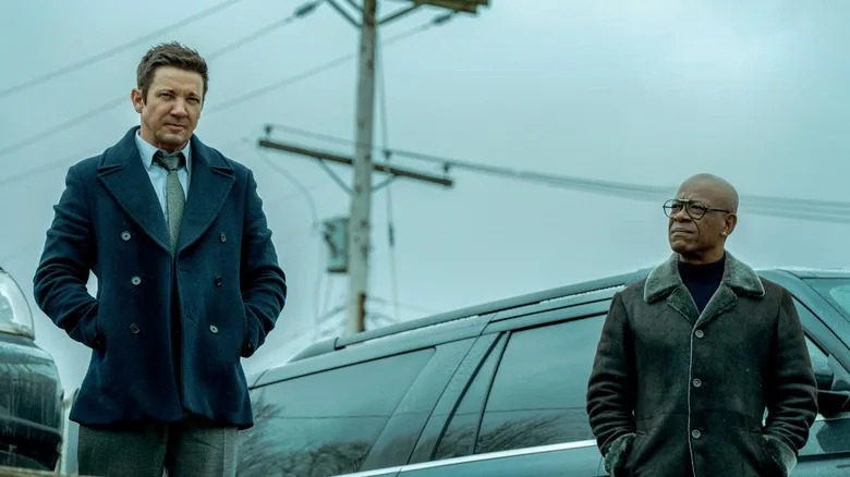 Mike McLusky and Frank Moses stand by a car in "Mayor of Kingstown" (2021)