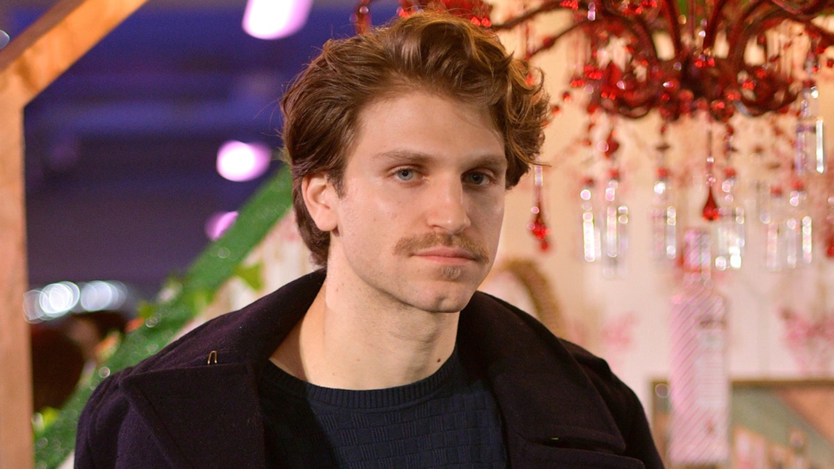 Keegan Allen poses for a photo