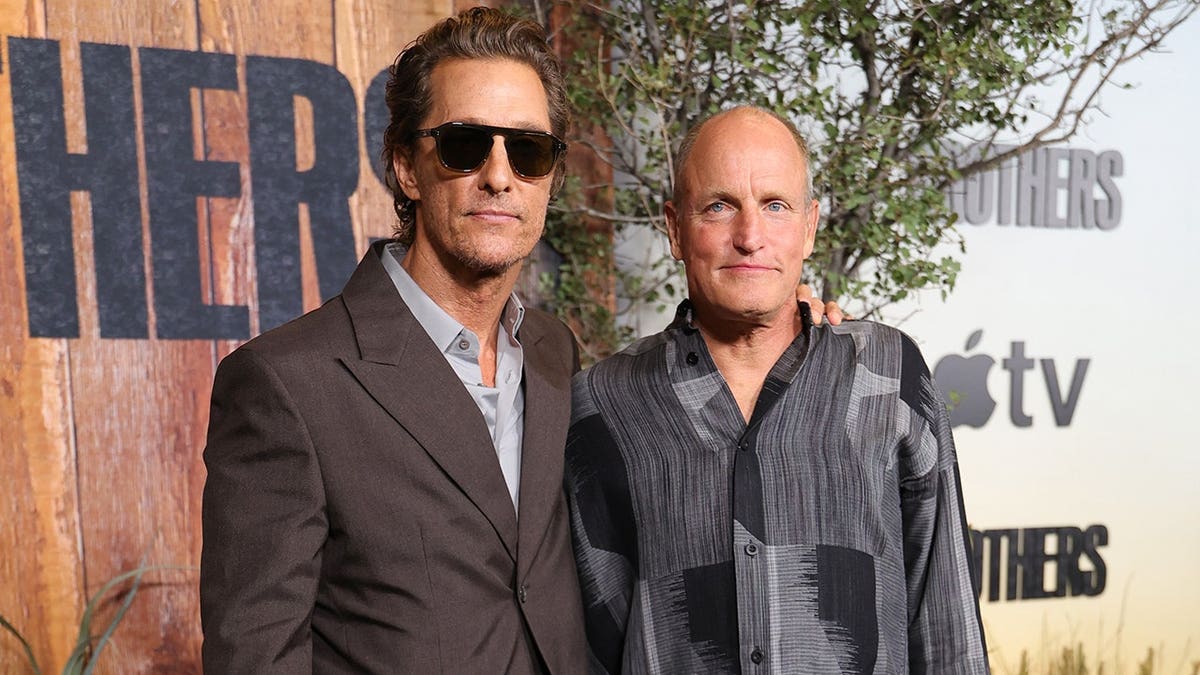 Matthew McConaughey and Woody Harrelson posing together at the premiere of Brothers