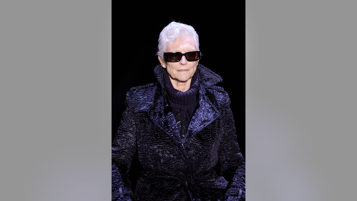 Maye Musk walks the runway at a fashion show.