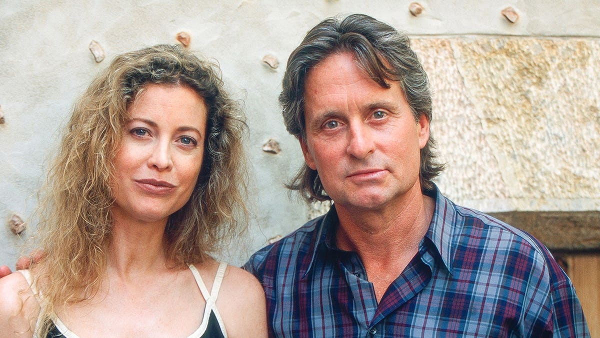 Michael Douglas and Diandra Luker pose together outdoors in Valldemossa.