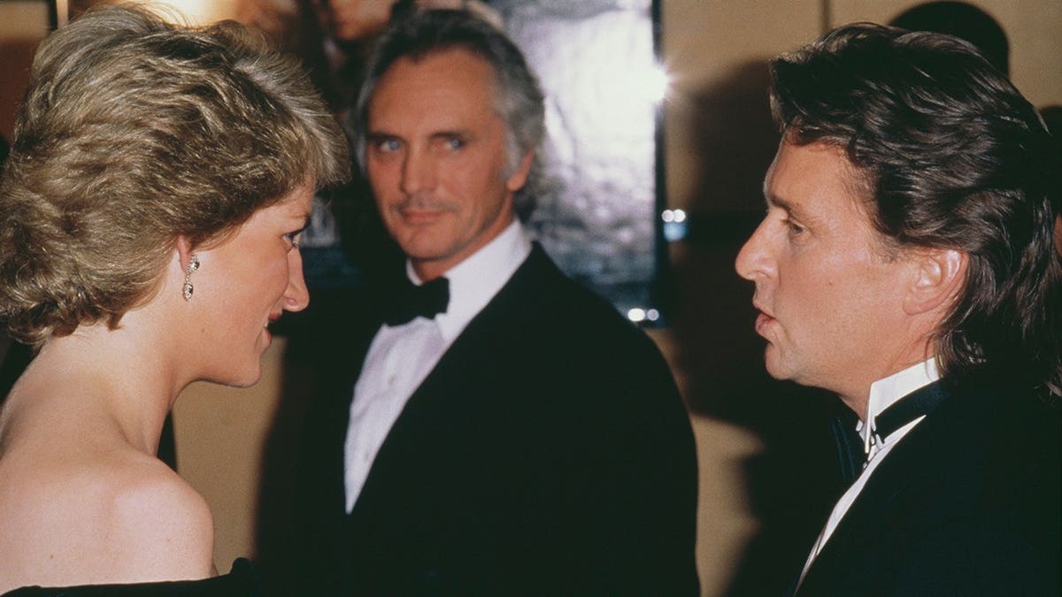 Diana, Princess of Wales talks to Michael Douglas at the London premiere of Wall Street.