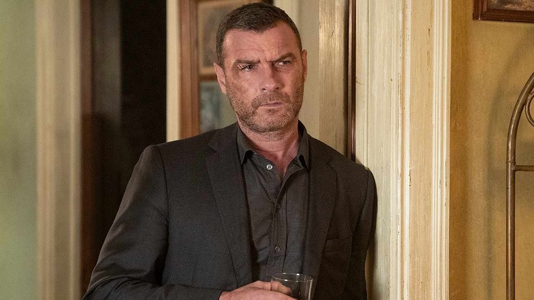Liev Schreiber as Ray Donovan, leaning against a wall in Ray Donovan.