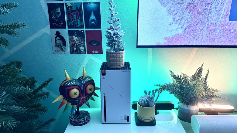 An Xbox Series X in the official Starfield console wrap sitting next to a Christmas tree and other decorations.