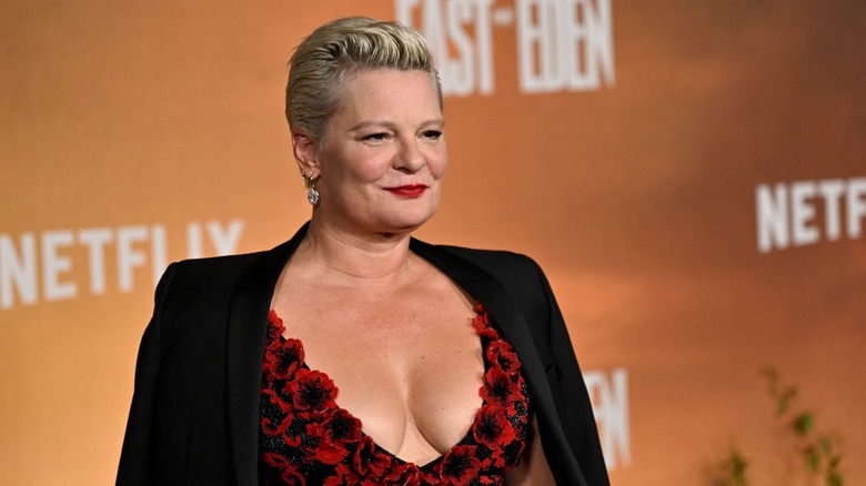 Martha Plimpton posing on the red carpet in a plunging red and black dress at the East of Eden premiere